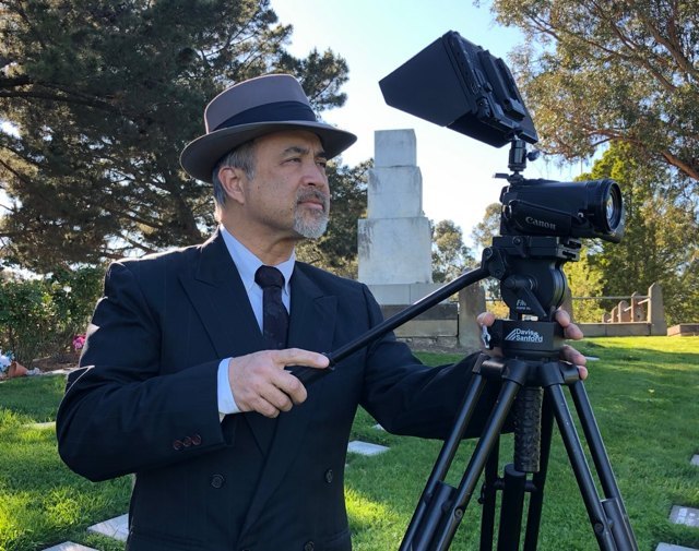 A Distant Memorials camera operator filming with a professional Canon camera